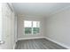 Bright bedroom with gray flooring, a window, and a closet, offering plenty of storage at 4939 Floramar Ter # 812, New Port Richey, FL 34652
