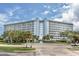 Stunning exterior view of a multi-story condominium complex with balconies and lush landscaping at 4939 Floramar Ter # 812, New Port Richey, FL 34652