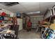 This cluttered garage contains shelves, work benches, tools, and a white refrigerator at 4939 Floramar Ter # 812, New Port Richey, FL 34652