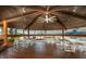Interior of the community gazebo with tables, chairs, ceiling fan and waterfront view at 4939 Floramar Ter # 812, New Port Richey, FL 34652