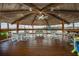 Interior of the community gazebo with tables, chairs, ceiling fan and waterfront view at 4939 Floramar Ter # 812, New Port Richey, FL 34652