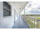 Wide hallway with gray floors, doors, windows, and railings at 4939 Floramar Ter # 812, New Port Richey, FL 34652