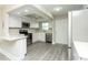 Modern kitchen with stainless steel appliances, white cabinets, and gray floors at 4939 Floramar Ter # 812, New Port Richey, FL 34652