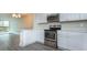 Updated kitchen with stainless steel appliances, white cabinetry, and bar seating at 4939 Floramar Ter # 812, New Port Richey, FL 34652