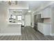 Bright, open kitchen featuring stainless steel appliances with white cabinetry and ample counter space at 4939 Floramar Ter # 812, New Port Richey, FL 34652