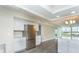 Open concept kitchen with stainless steel refrigerator and an island, seamlessly connects to the living area at 4939 Floramar Ter # 812, New Port Richey, FL 34652