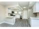 Bright kitchen with stainless steel appliances and gray wood-look floors at 4939 Floramar Ter # 812, New Port Richey, FL 34652