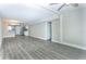 Open-concept living room features gray flooring and neutral paint, seamlessly connected to the kitchen area at 4939 Floramar Ter # 812, New Port Richey, FL 34652