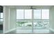 Bright room with large windows offering city views and a ceiling fan, perfect for relaxation at 4939 Floramar Ter # 812, New Port Richey, FL 34652