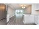 Open living area boasts natural light and water views with an adjacent kitchen with stainless steel refrigerator at 4939 Floramar Ter # 812, New Port Richey, FL 34652