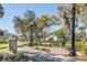 A picturesque park with benches, a stone wall, and tall trees with Spanish moss at 4939 Floramar Ter # 812, New Port Richey, FL 34652