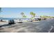 This parking lot by the water contains a row of parked cars and some palm trees at 4939 Floramar Ter # 812, New Port Richey, FL 34652