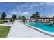 Community pool with a nearby gazebo in a waterfront community, and boat docks in the background at 4939 Floramar Ter # 812, New Port Richey, FL 34652