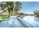 This waterfront view contains a concrete walkway with lush green grass on the left at 4939 Floramar Ter # 812, New Port Richey, FL 34652