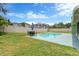 View of a spacious backyard featuring a private pool and an outdoor dining set at 5021 Bridgeport Dr, Safety Harbor, FL 34695