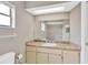 Well-lit bathroom featuring tiled shower, vanity with mirror, and neutral color scheme at 5021 Bridgeport Dr, Safety Harbor, FL 34695