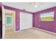 Bedroom showcasing hardwood floors, closet, and a window at 5021 Bridgeport Dr, Safety Harbor, FL 34695
