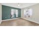 Bright bedroom featuring wood floors, neutral paint, and well lit with two windows at 5021 Bridgeport Dr, Safety Harbor, FL 34695