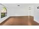 Bright and airy living room showcasing sleek wood flooring, a window, and modern lighting at 5021 Bridgeport Dr, Safety Harbor, FL 34695