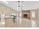 Spacious living room featuring a stone fireplace, tile flooring, and plenty of natural light at 5021 Bridgeport Dr, Safety Harbor, FL 34695