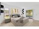 Relaxing main bedroom featuring a comfortable bed, an accent wall, and sliding glass doors at 5021 Bridgeport Dr, Safety Harbor, FL 34695