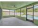 View of screened porch leading out to the private pool and lush backyard at 5021 Bridgeport Dr, Safety Harbor, FL 34695