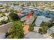 Waterfront home aerial view showcases lush landscaping, neighborhood, and canal access for boating at 5348 Lawrence Ln, New Port Richey, FL 34652
