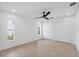 Clean bedroom with two windows and closet, features a ceiling fan and light wood floors at 5348 Lawrence Ln, New Port Richey, FL 34652