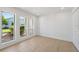 Bright bedroom with three windows offering lush outdoor views and beautiful, light-colored wood flooring at 5348 Lawrence Ln, New Port Richey, FL 34652