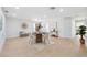 Bright dining room with a round wood table and views of the entrance at 5348 Lawrence Ln, New Port Richey, FL 34652