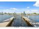 View from dock to the canal with boat lifts, neighboring homes, and a clear blue sky at 5348 Lawrence Ln, New Port Richey, FL 34652