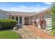 Inviting home entrance with a decorative wreath, a stone pathway, and lush landscaping at 5348 Lawrence Ln, New Port Richey, FL 34652