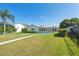 Charming single-story home with a well-maintained lawn, beautiful lawn, and inviting walkway at 5348 Lawrence Ln, New Port Richey, FL 34652