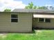 Side exterior view of a home, showing an awning, and a window at 6030 17Th St, Zephyrhills, FL 33542
