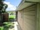 Exterior shot of the back of a single-story home with simple windows and green grass at 6030 17Th St, Zephyrhills, FL 33542