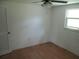 Neutral bedroom with hardwood flooring, ceiling fan, and natural light from a window at 6030 17Th St, Zephyrhills, FL 33542