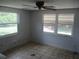 Empty bedroom with two windows letting in natural light and ceiling fan at 6030 17Th St, Zephyrhills, FL 33542