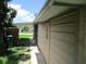 Exterior shot showing home's siding and utility area under a partly cloudy sky at 6030 17Th St, Zephyrhills, FL 33542