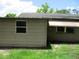 Exterior shot showing home's siding and window under a partly cloudy sky at 6030 17Th St, Zephyrhills, FL 33542