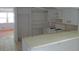 Simple kitchen with white cabinets and breakfast bar overlooking the living area at 6030 17Th St, Zephyrhills, FL 33542