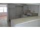 Bright kitchen features white cabinets, shelving and a breakfast bar overlooking the living space at 6030 17Th St, Zephyrhills, FL 33542