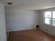 Bright living room featuring hardwood floors, a window letting in natural light, and freshly painted walls at 6030 17Th St, Zephyrhills, FL 33542