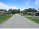 Neighborhood street view with well-maintained homes and green lawns on a sunny day at 6030 17Th St, Zephyrhills, FL 33542
