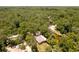 Aerial view of riverfront home surrounded by abundant trees at 6410 Amelia Ln, Dade City, FL 33523
