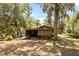 Backyard with a wooden building that features a screened-in porch at 6410 Amelia Ln, Dade City, FL 33523