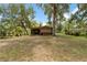 Spacious backyard featuring a wooden structure with a screened-in porch at 6410 Amelia Ln, Dade City, FL 33523