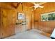 Wood-paneled bedroom with natural light, practical wall features and a cozy atmosphere provides functionality and charm at 6410 Amelia Ln, Dade City, FL 33523