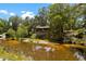 Quaint home perched above the river with beautiful surrounding trees and vegetation at 6410 Amelia Ln, Dade City, FL 33523