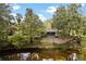 Charming home with a covered porch overlooking the river and lush, mature trees at 6410 Amelia Ln, Dade City, FL 33523