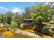 Exterior view of riverfront home, featuring screened porch and deck overlooking serene river and lush greenery at 6410 Amelia Ln, Dade City, FL 33523